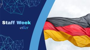Promotional graphic announcing a staff week offer in Germany, featuring the German national flag waving against a blue sky with modern geometric design elements on a blue background