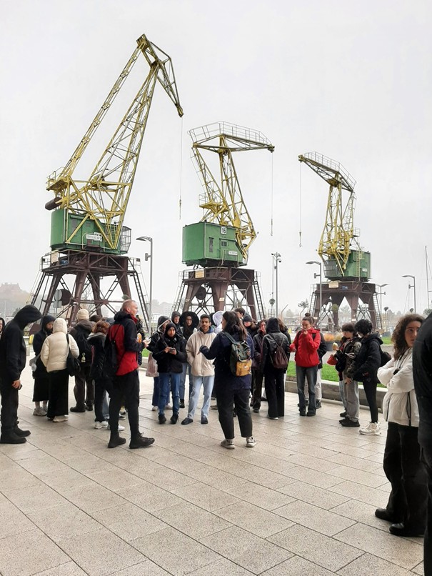 Trip to Wolin Island – a group of students with the Szczecin Cranes in the background