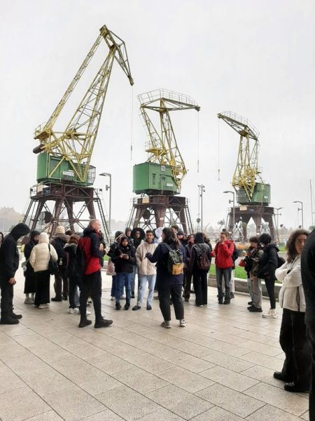 Trip to Wolin Island – a group of students with the Szczecin Cranes in the background