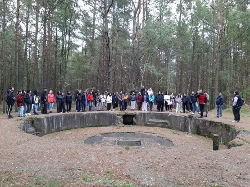 A group of students at the entrance to an underground bunker