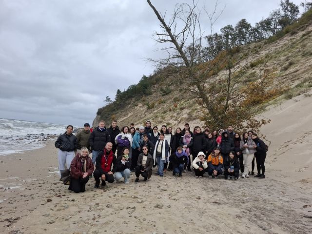 Group photo of students and their supervisors on the beach