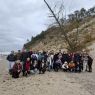 Group photo of students and their supervisors on the beach
